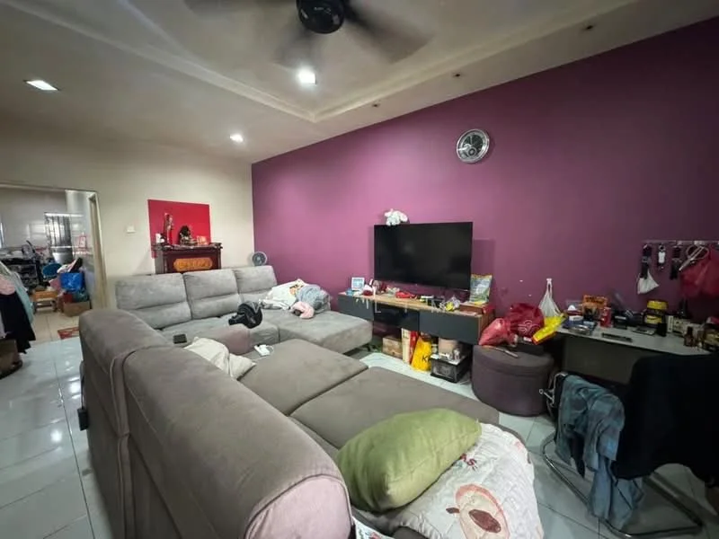 Living features: grey fabric sectional sofa, 2-seater grey fabric sofa, coffee table, wall-mounted TV, TV console, purple accent wall, white tiled flooring, ceiling fan, decorative wall clock, various items on shelves, area rug; style: modern. Room features: white walls, open doorway leading to another room, visible clutter.