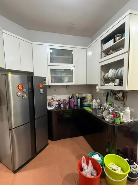 Kitchen features: white cabinetry with glass-front upper cabinets, black countertop, stainless-steel fridge, built-in sink, various kitchen appliances visible, multiple containers and bottles on countertop, ceramic tile flooring, wall-mounted shelves, decorative wall hangings; style: modern.