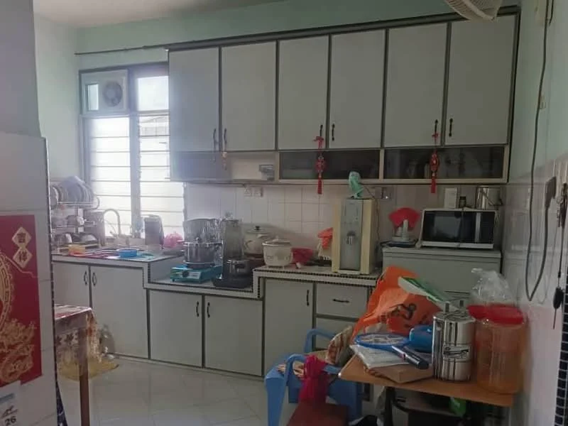 Kitchen features: white cabinetry with grey trim, stainless-steel sink, built-in microwave, freestanding range oven, ceramic tile backsplash, countertop with clutter, kitchen table with plastic chairs, various kitchen utensils and appliances visible, window with horizontal slats, white tiled flooring, wall-mounted air conditioning unit.