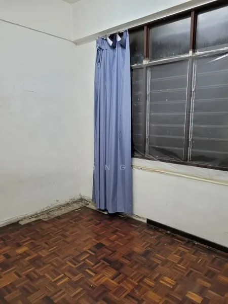 Room features: white painted walls, wooden parquet flooring, blue curtain, window with horizontal slats, corner of room with visible wear.