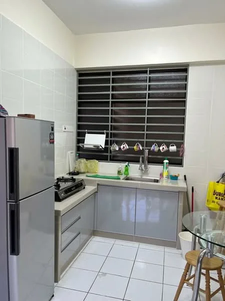 Kitchen features: grey cabinetry, white countertop, stainless-steel fridge, 4-burner gas hob, single-bowl stainless-steel sink, chrome pull-down faucet, white tiled walls, white tiled flooring, window with horizontal slats, glass dining table, wooden stools; style: modern.