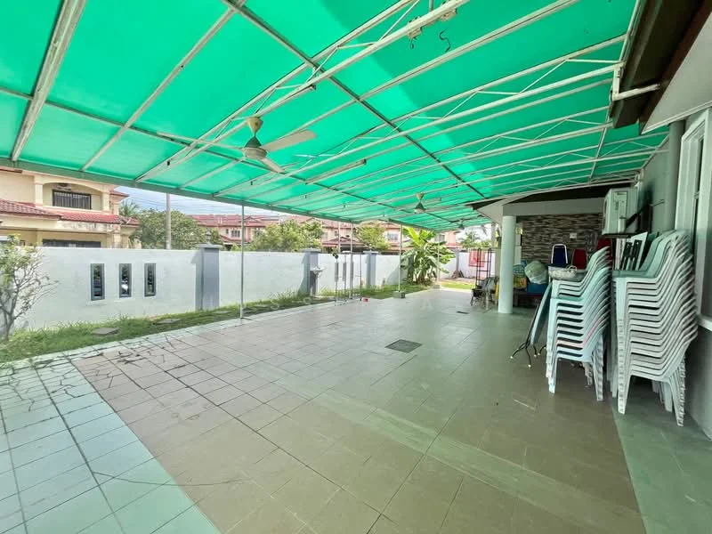 Exterior features: covered outdoor area with green canopy, tiled flooring, exposed concrete wall, manicured landscaping, stacked plastic chairs, ceiling fans, outdoor lighting, paved walkway; style: modern.