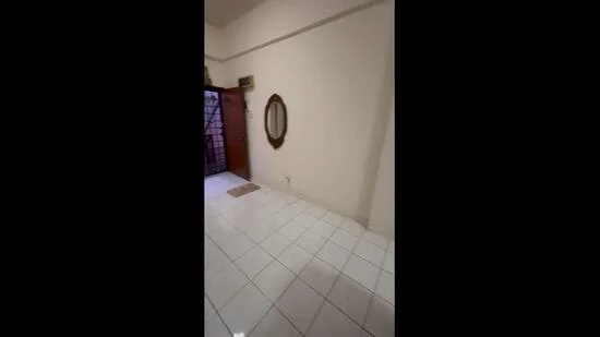 Room features: white painted walls, glossy white tile flooring, mirror on wall, wooden door, door mat.