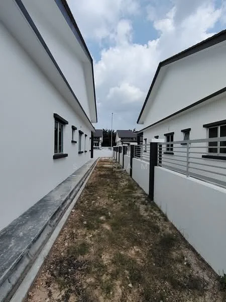 Exterior type: linked terrace house; features: white painted facade, flat roof, 2-storey, concrete pathway, landscaped side yard, metal railing, windows with black frames, driveway, surrounded by greenery; style: modern.
