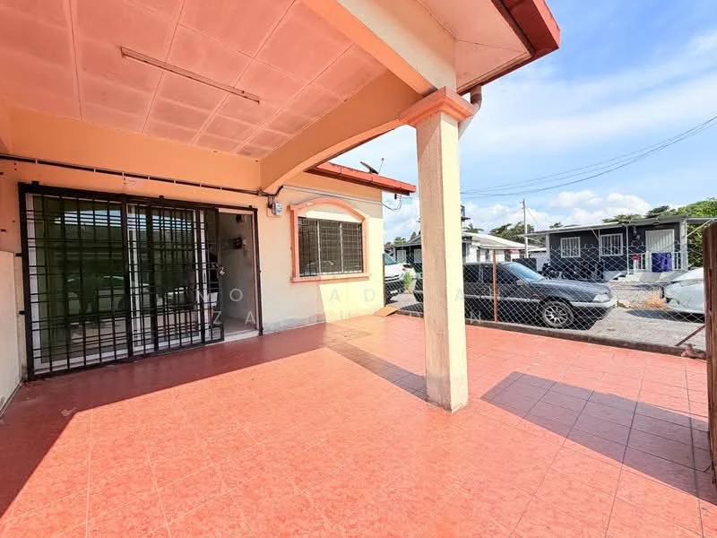 Exterior type: detached bungalow; features: red tiled roof, cream painted facade, front porch with tiled flooring, security grille on entrance, surrounded by fencing, driveway visible, landscaped area with grass, outdoor lighting fixtures; style: modern.