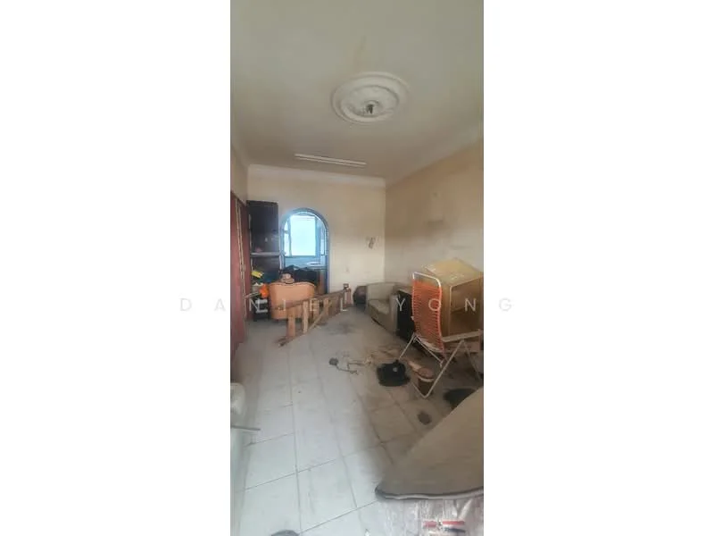 Room features: white painted walls, ceiling rose, tiled flooring, window with arch, wooden furniture, sofa, coffee table, cluttered space.