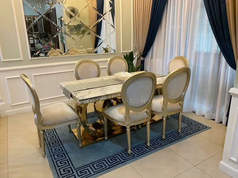 Dining features: marble dining table, 6-seater dining table, golden upholstered dining chairs, blue area rug with geometric pattern, decorative mirror on wall, crown moulding, sheer curtains, dark blue drapes, tile flooring, chandelier; style: luxury.