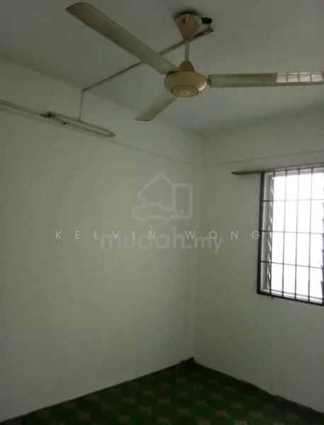 Room features: white painted walls, ceiling fan, window with metal grille, green patterned flooring.