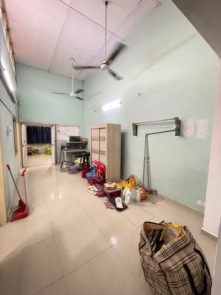 Room features: light green painted walls, white ceiling, tile flooring, 2 ceiling fans, wooden storage cabinet, metal clothing rack, various bags and items on the floor, computer desk with chair, doorway leading to another room; style: modern.
