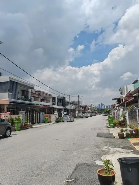 Exterior type: linked terrace house; features: two-storey houses, driveways with parked cars, manicured front gardens, paved walkway, street lighting, overhead power lines, surrounding greenery, urban residential area; style: modern.
