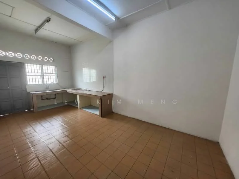 Kitchen features: white painted walls, tile flooring in beige, single-bowl stainless-steel sink, countertop with laminate surface, window with grid pattern, cabinets below countertop, no visible appliances, fluorescent ceiling light.