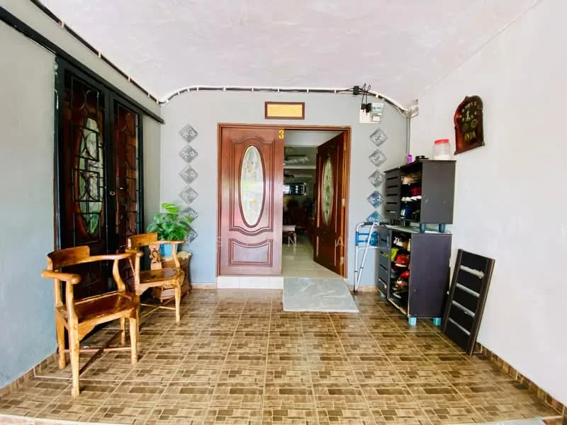 Room features: double wooden doors with glass panels, grey painted walls, tiled flooring in brown, two wooden chairs, small potted plant, decorative wall clock, shelving unit with various items, shoe rack, light fixture on ceiling; style: traditional.