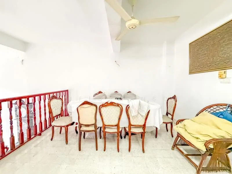 Dining features: white walls, ceiling fan, dining table with white tablecloth, 8 wooden dining chairs with upholstered seats, wooden railing, light-colored flooring, decorative wall art, natural light from window; style: traditional.