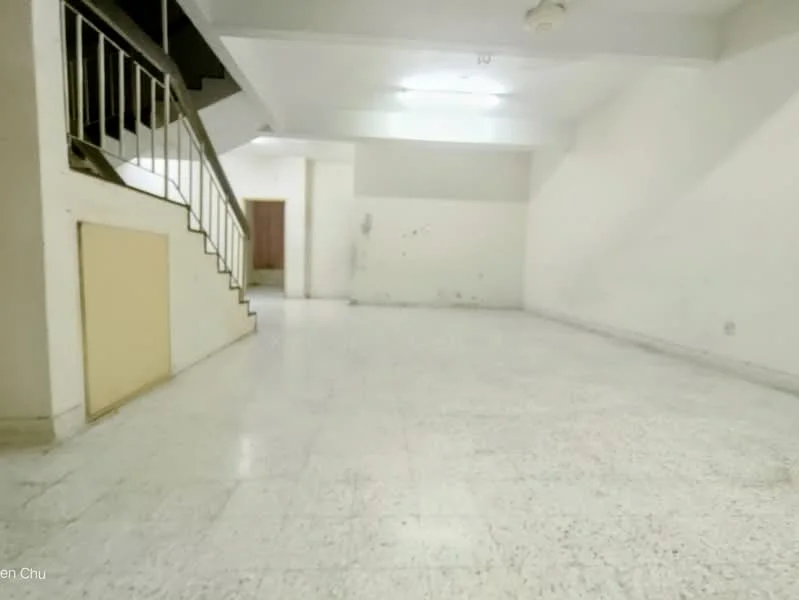Room features: white painted walls, marble flooring, ceiling lights, staircase with metal railing, empty space, no visible furniture, neutral color scheme, high ceiling; style: minimalist.
