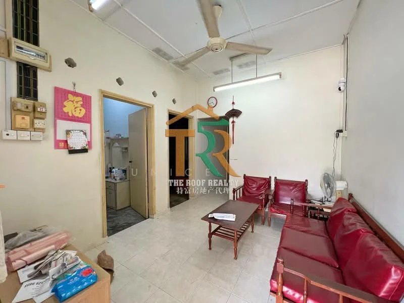 Living features: white painted walls, tile flooring, ceiling fan, 3-seater red leather sofa, 2 single red leather chairs, wooden coffee table, wall-mounted light fixture, doorway to adjacent room, window with curtain, decorative wall art. Room features: doorway leading to bathroom, unknown wall features.