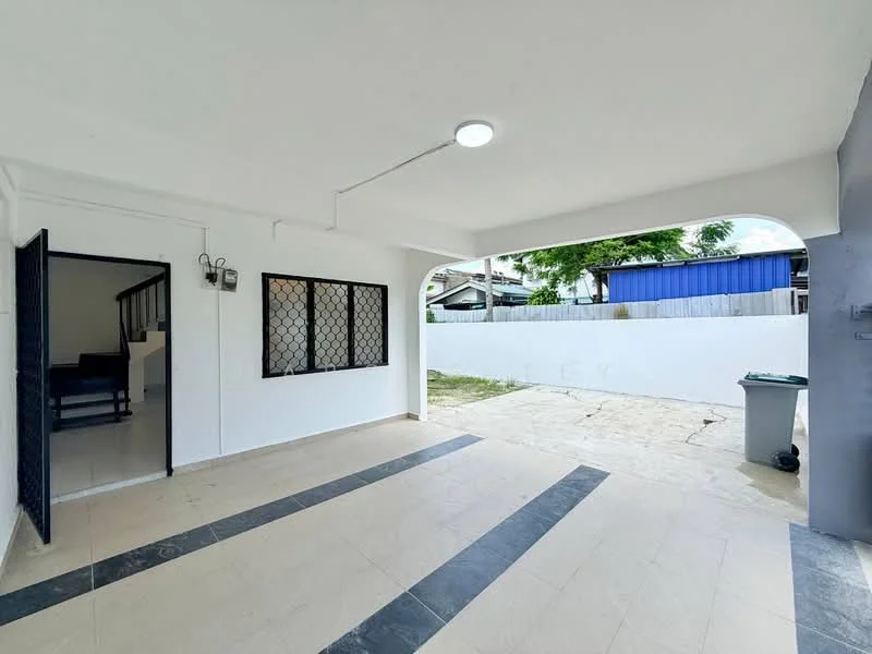Exterior type: linked terrace house; features: covered car porch, white painted walls, grey accent wall, sliding door, security grille on window, paved flooring, outdoor space, garden area, visible garbage bin, fenced perimeter, natural light from overhead lighting; style: modern.