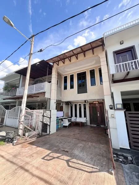 Exterior type: linked terrace house; features: cream painted facade, wooden beams on upper level, large windows, front porch area, paved walkway, balcony on upper level, metal railing, outdoor seating area, street lamp, power lines visible; style: modern.