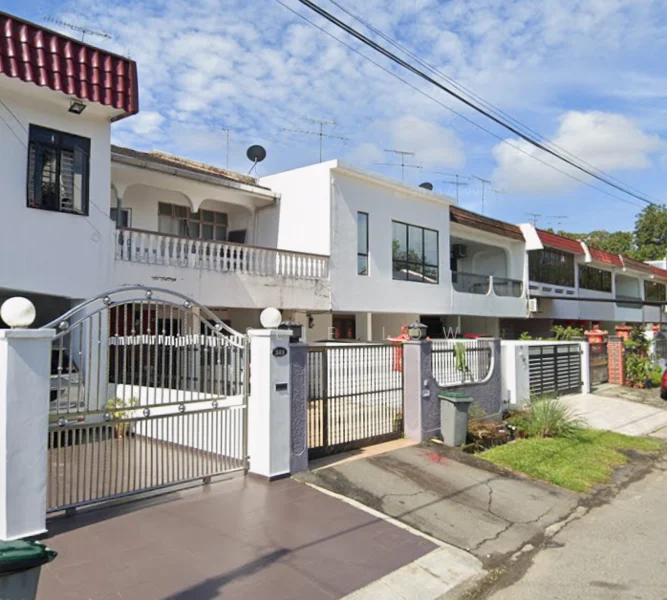 Exterior type: linked terrace house; features: white painted facade, red tiled roof, balconies on upper floors, metal gate, paved driveway, manicured lawn, fence with decorative pillars, multiple antennas on roof, surrounded by greenery, two-storey structure; style: modern.