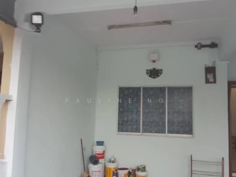Room features: white painted walls, concrete flooring, ceiling light fixture, window with grid pattern, wall-mounted smoke detector, paint cans, cleaning supplies, ladder.
