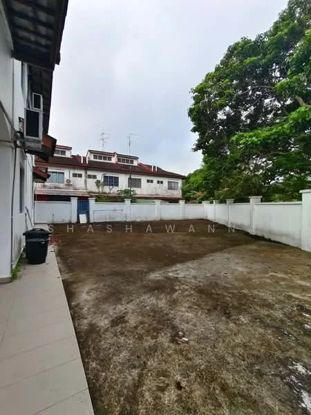 Exterior type: linked terrace house; features: empty yard area, concrete wall fencing, paved walkway, mature trees, two-storey linked terrace houses in background, overcast sky; style: modern.