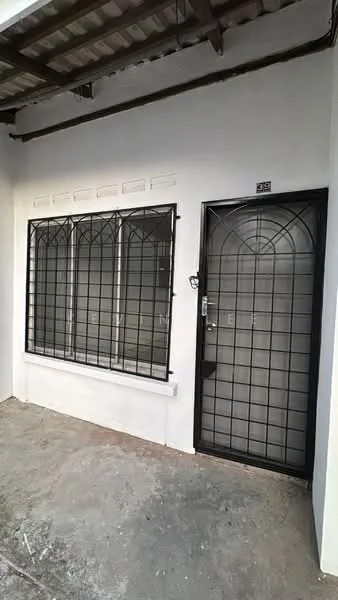 Exterior features: black metal security grille on windows, black metal door with security grille, white painted facade, concrete flooring, overhead roof with metal sheeting, three-panel window design, number plaque on door; style: modern.