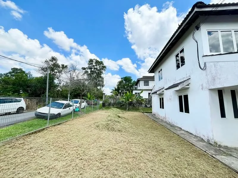 Exterior type: detached bungalow; features: white painted facade, single-storey, manicured lawn, fenced yard, paved walkway, multiple windows, surrounded by greenery, driveway, adjacent to road; style: modern.