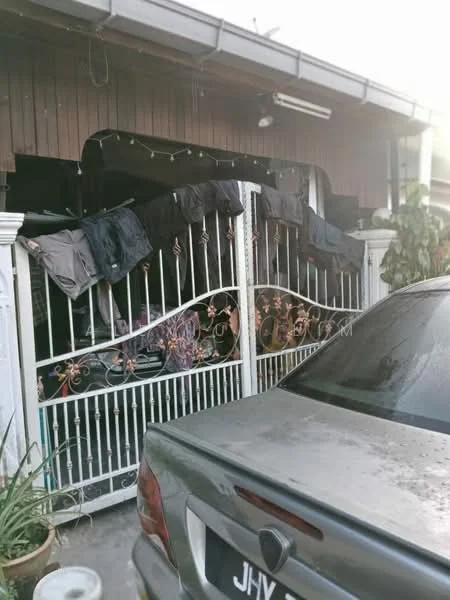 Exterior features: metal gate with decorative design, white painted fence, wooden facade, clothes hanging on the gate, potted plants, grey car parked in front; style: traditional.