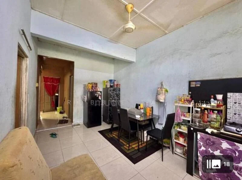 Living features: light blue painted walls, white ceiling, tile flooring, 3-seater fabric sofa in beige, area rug with geometric pattern, dining table with 4 chairs, black refrigerator, kitchenette with sink, countertop with storage cabinets, wall-mounted shelves, ceiling fan. Room features: doorway leading to hallway, light blue painted walls, tile flooring.