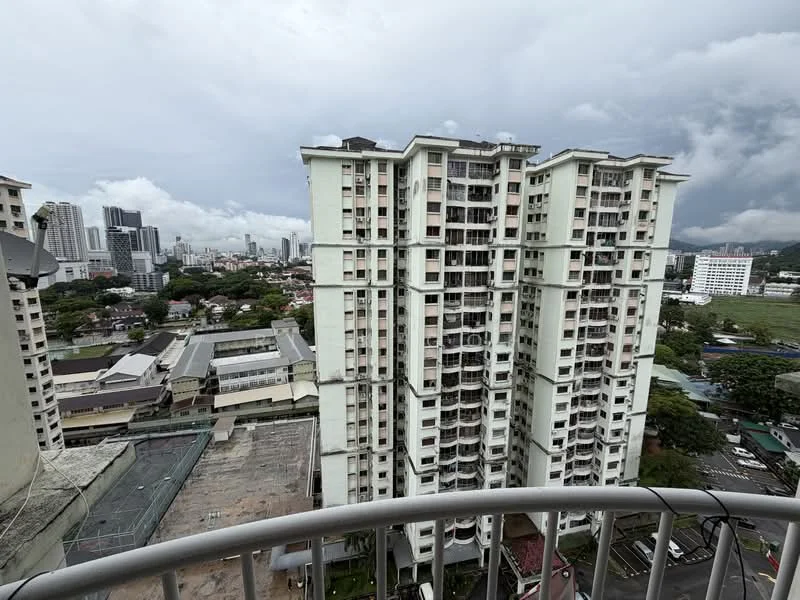 Exterior type: high-rise condominium; features: multiple-storey building, balconies on each floor, glass windows, concrete facade, surrounded by urban landscape, view of city skyline, nearby low-rise buildings, green spaces visible in the background; style: modern.