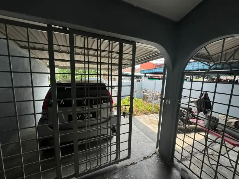 Exterior type: car porch; features: grilled gate, concrete flooring, covered roof, space for one car, adjacent garden area, surrounding walls, paved pathway, outdoor storage area; style: modern.