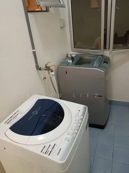 Laundry features: top-load washing machine in white, top-load washing machine in grey, blue ceramic tile flooring, white painted walls, window for natural light, plumbing fixtures visible, ventilation window.