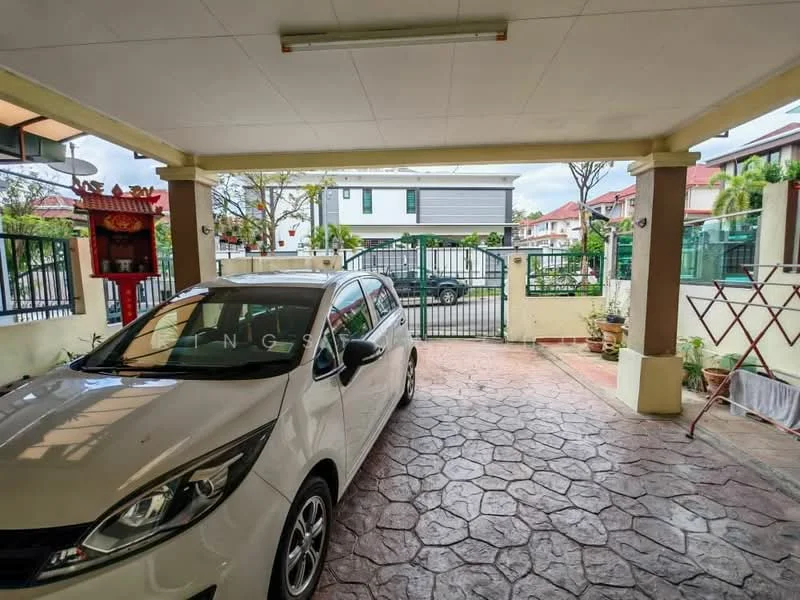 Exterior type: car porch; features: paved flooring with stone pattern, covered car porch, white painted walls, green gate, surrounded by fencing, garden area with potted plants, clothes drying rack, adjacent residential buildings; style: modern.