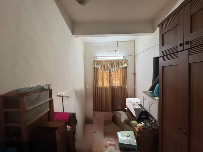 Room features: white painted walls, ceiling with light fixture, carpet flooring, curtains, wooden wardrobe, wooden shelving unit, various items on floor, natural light from window.