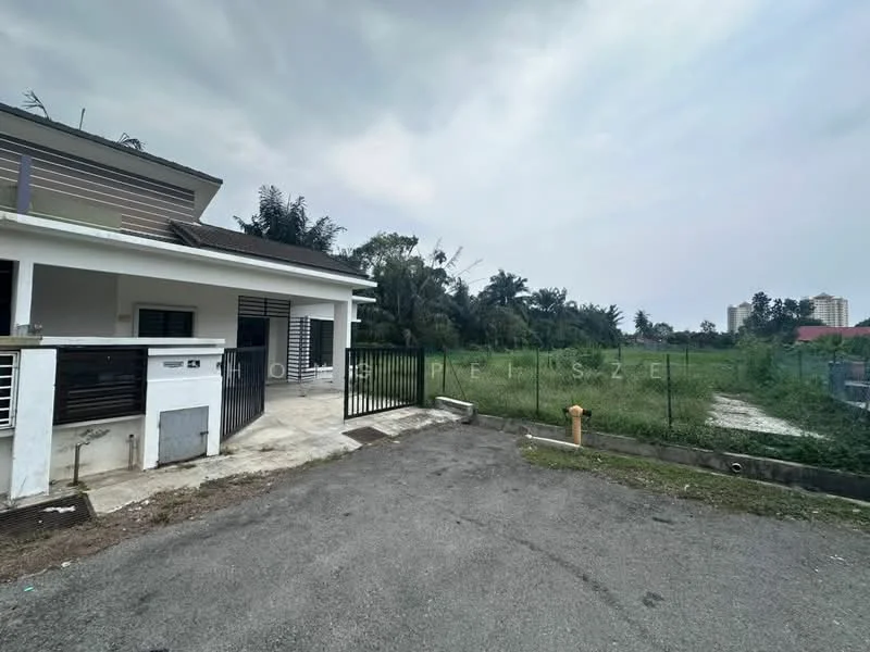 Exterior type: semi-detached house; features: concrete driveway, manicured lawn, fenced yard, surrounding greenery, adjacent vacant land, single-storey structure, gated entrance; style: modern.
