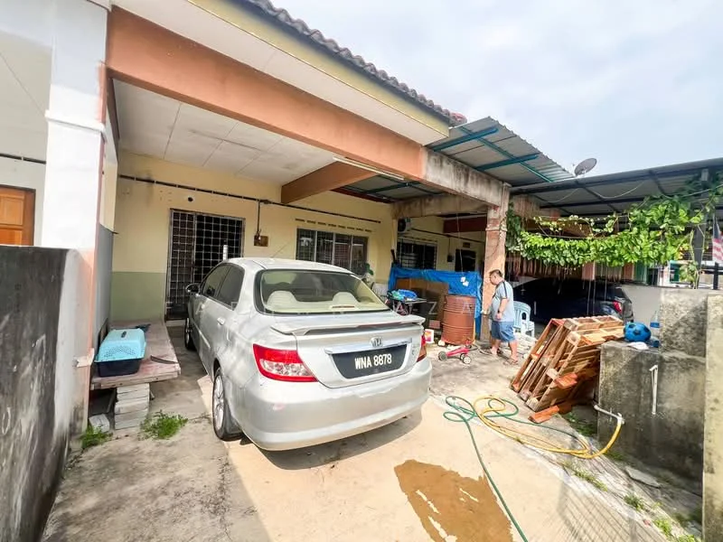 Exterior type: linked terrace house; features: car porch with awning, grey painted facade, single-storey, manicured lawn, paved driveway, outdoor storage area, covered walkway, garden with climbing plants, visible windows, satellite dish on roof; style: traditional.