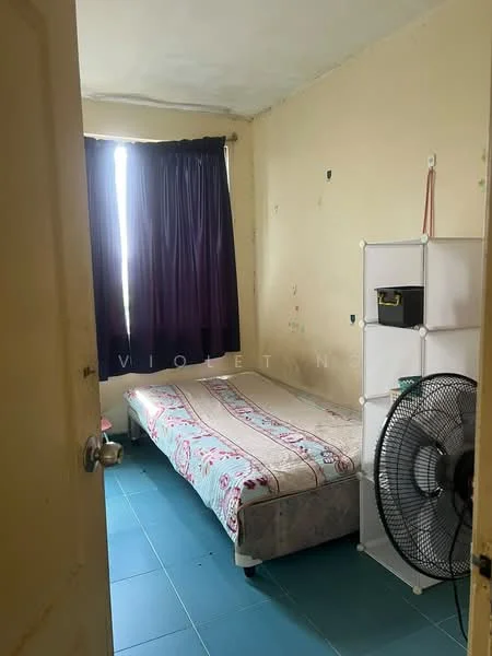 Bedroom features: single bed with patterned bedding, blue tiled flooring, purple curtains, white shelving unit, standing fan, painted walls with some wear, window with natural light, door leading to hallway.