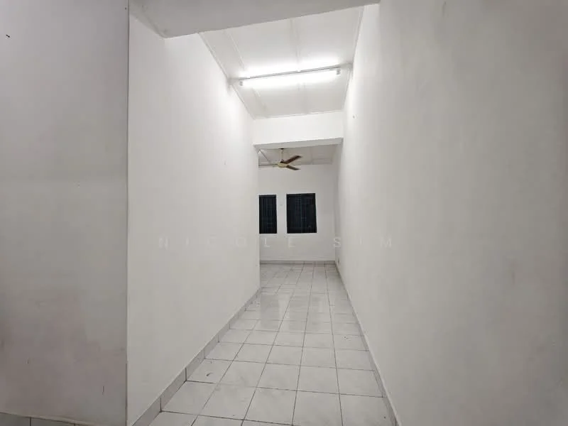 Room features: white painted walls, tile flooring, ceiling with fluorescent lighting, ceiling fan, two windows with grilles.