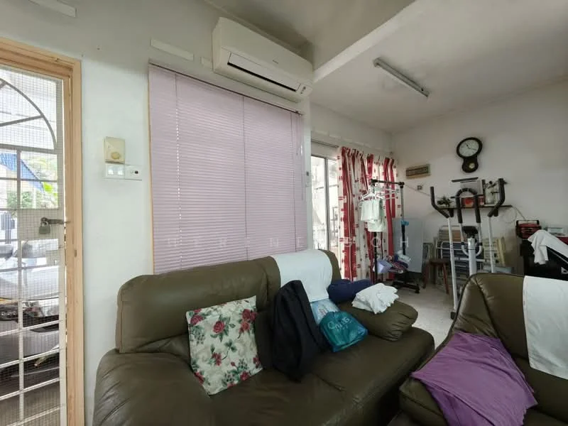 Living features: brown leather sofa, floral throw pillows, white wall, light-colored flooring, wall-mounted air conditioning unit, vertical blinds in light purple, wall clock, exercise equipment, clothes drying rack, decorative wall art, window with view to outside, light fixture on ceiling.