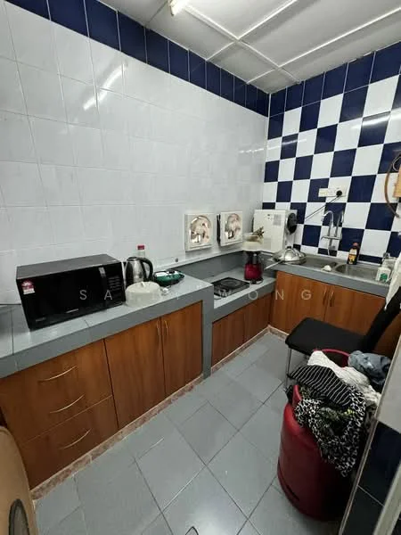 Kitchen features: grey laminate countertop, wood cabinetry in brown, white tiled walls, blue and white checkered backsplash, stainless-steel sink, 4-burner gas hob, microwave, kettle, dishwasher, tile flooring, refrigerator, black stool, laundry basket with clothes; style: modern.