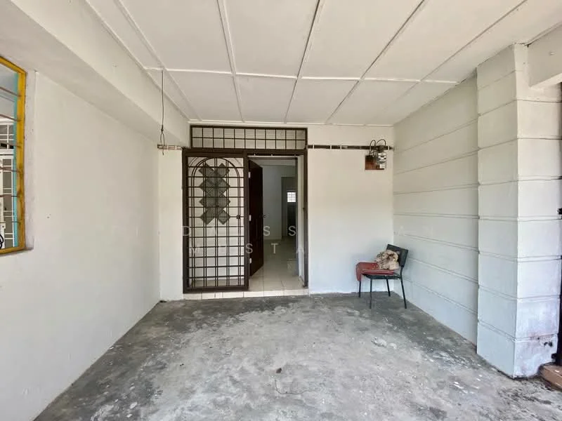 Room features: concrete flooring, white painted walls, metal security grille door, open layout, ceiling with exposed beams, light fixture, window with metal bars, chair.