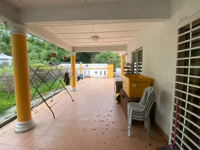 Room features: terracotta tile flooring, white painted walls, yellow painted columns, ceiling light fixture, outdoor laundry drying rack, plastic chairs, storage box, window with security bars; view: garden.