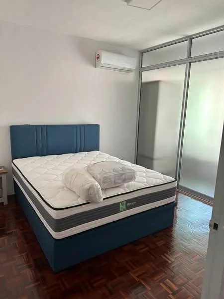 Bedroom features: queen-size bed with blue upholstered headboard, mattress with white bedding, white bedroll, wooden parquet flooring, wall-mounted split AC unit, large glass sliding wardrobe, white walls, ceiling light fixture; style: modern.