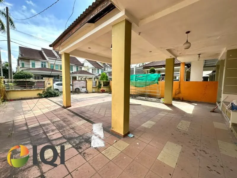 Exterior type: linked terrace house; features: paved flooring, yellow painted columns, overhead ceiling with light fixture, open outdoor space, surrounded by residential houses, partially covered area, fenced perimeter, visible parking area; style: modern.