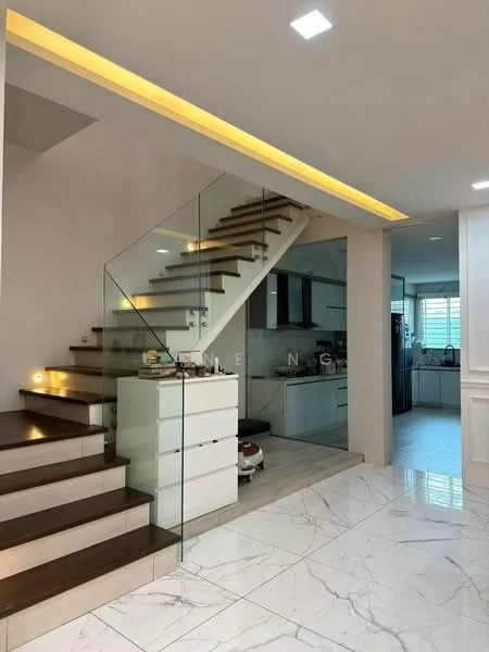 Room features: floating staircase with wooden steps, glass railing, marble tile flooring, recessed ceiling lights, LED strip lighting along staircase, open kitchen view, white painted walls, kitchen cabinetry visible in background; style: modern.