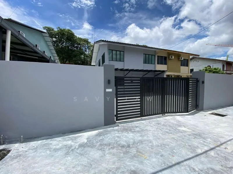Exterior type: semi-detached house; features: grey painted facade, black metal gate, concrete driveway, two-storey building, windows with air conditioning units, manicured landscaping, clear blue sky, clouds, surrounding greenery; style: modern.