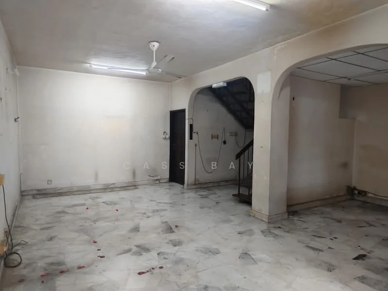 Room features: marble flooring, white painted walls, ceiling fan, staircase, arched doorways, fluorescent lighting, exposed electrical outlets, no visible furniture.