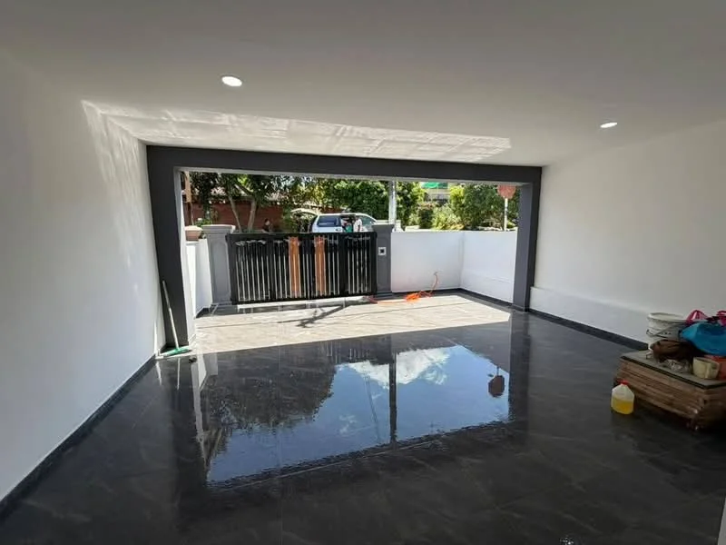 Room features: white painted walls, black tiled flooring, recessed downlights, large opening to outdoor area, sliding glass door, black metal gate, natural light from outside, clean and uncluttered space; style: modern; view: garden.