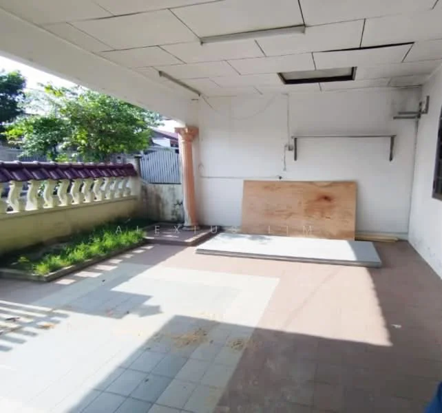 Exterior features: paved flooring, grass patches, exterior wall with white paint, overhead ceiling with tiles, wooden support column, window with grill, fence with decorative railing.