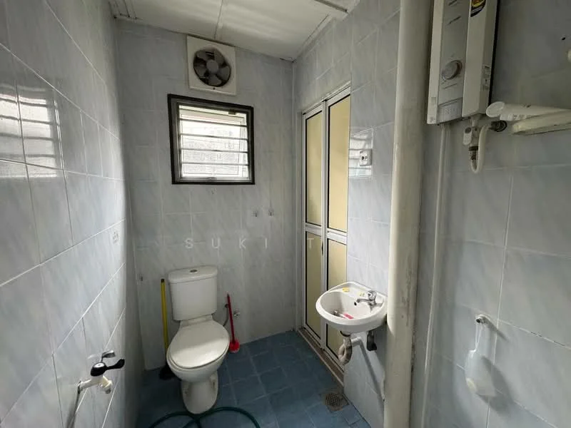 Bathroom features: white tiled walls, blue ceramic tile flooring, one-piece toilet, sink with pedestal, chrome faucet, shower with glass enclosure, exhaust fan, window for natural light.