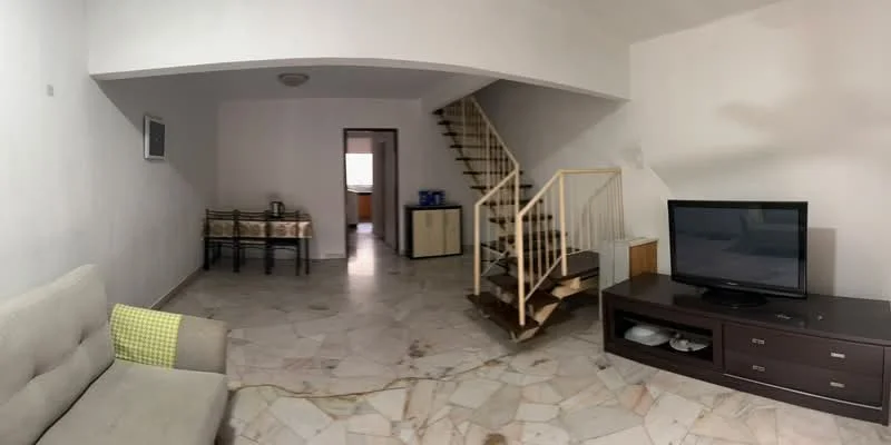 Living features: marble flooring, white painted walls, sofa in light grey, TV console, wall-mounted TV, ceiling light, staircase with wooden steps, decorative wall panel, large window, open layout; style: modern. Dining features: dining table with four chairs, white tablecloth, light fixture above table.